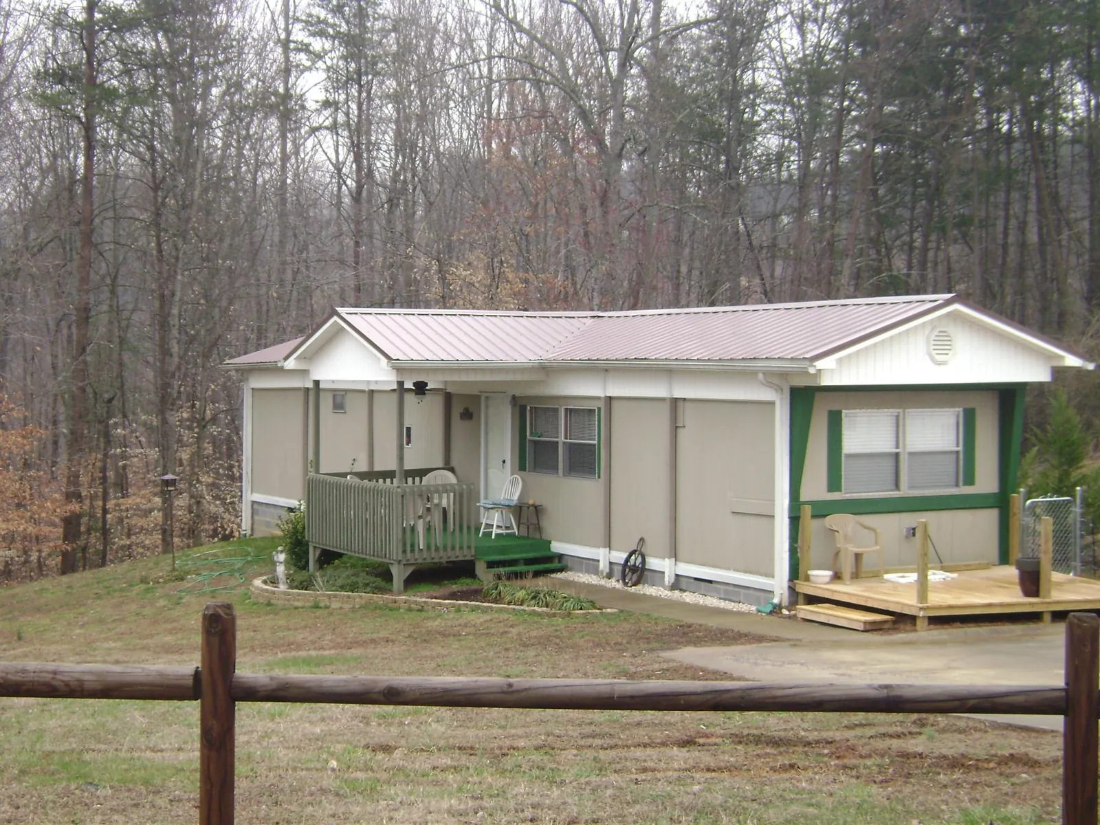 Mauve metal roof on a manufactured home with a new front deck in Enoree